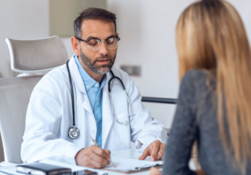 Male doctor discussing treatment options with a patient during a medical consultation