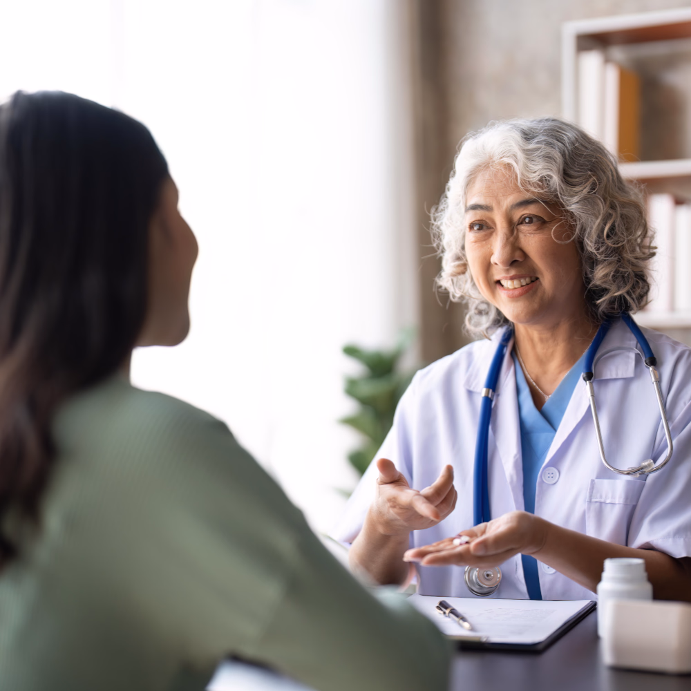 Female Doctor Discussing Treatment Plan With Patient At Her Clinic
