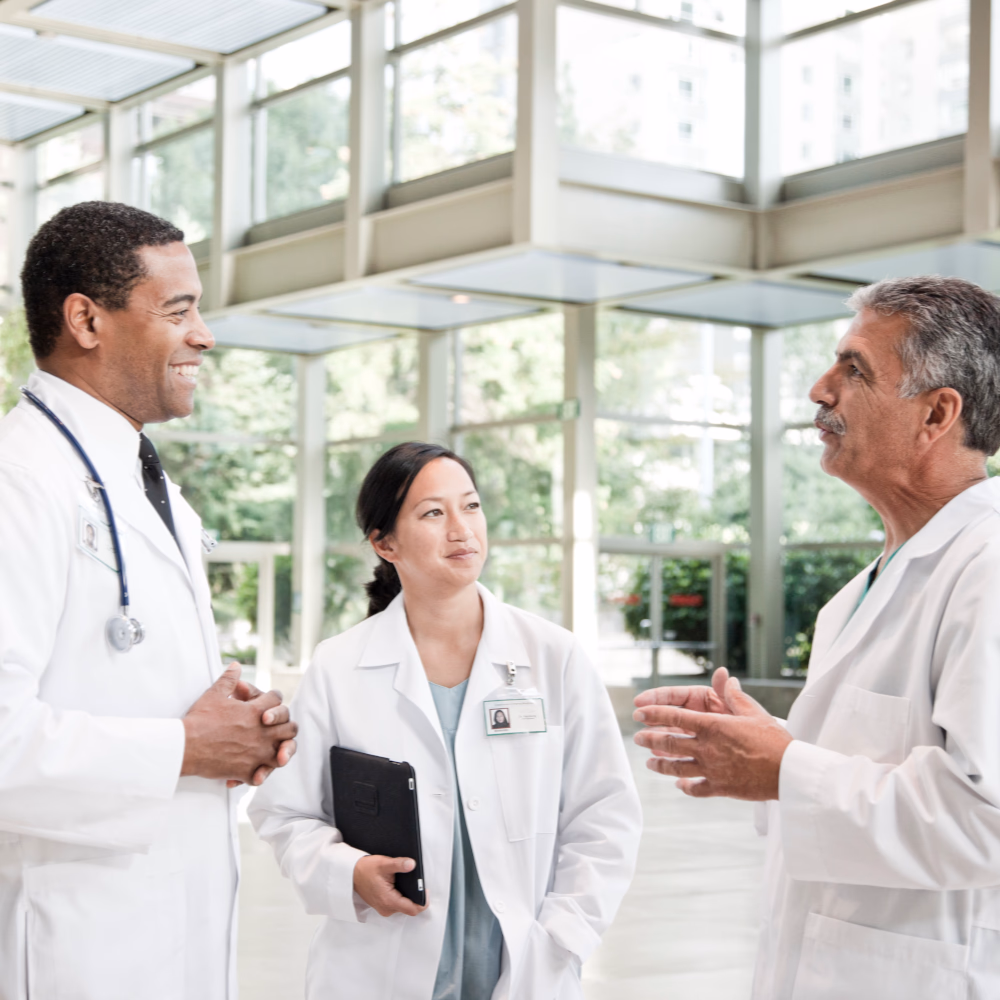 Group of healthcare professionals discussing patient care in a bright medical facility