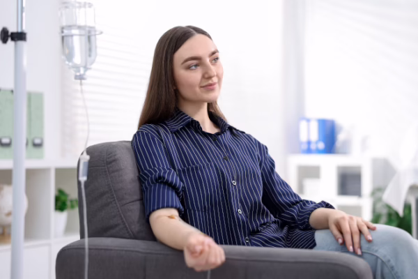 Young woman having an IV treatment while looking across the room